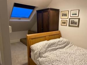 a bedroom with a bed with a dresser and a window at Stunning 1-Bed Studio in Windsor in Windsor