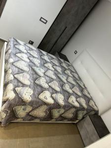a large bed in a room with a blanket at Roby & Simo in San Giorgio a Cremano