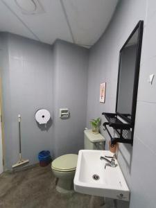 a bathroom with a toilet and a sink and a mirror at VILLA PUTRA CONDOMINIUM in Kuala Lumpur