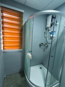 a shower with a glass door in a bathroom at VILLA PUTRA CONDOMINIUM in Kuala Lumpur