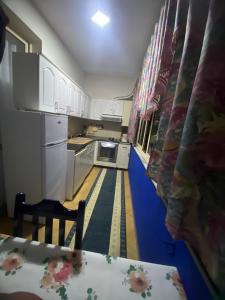 a kitchen with white cabinets and a blue floor at Elbasan view point in Elbasan