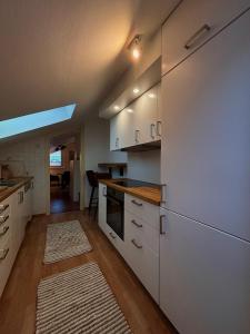 a kitchen with white cabinets and a counter top at RM-Apartments in Innsbruck