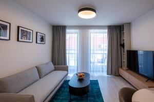 a living room with a couch and a tv at Apartment EDIAS ONE in Banská Bystrica