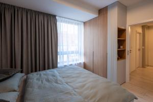 a bedroom with a bed and a large window at Apartment EDIAS ONE in Banská Bystrica