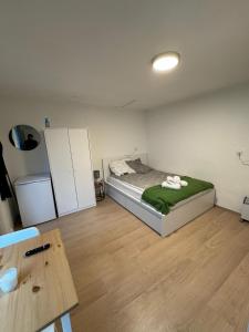 a small bedroom with a bed and a table at Main Appartement in Flörsheim