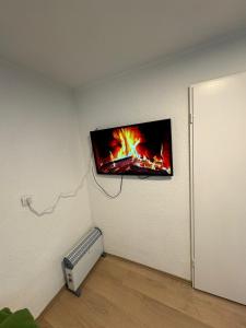 a tv hanging on a wall in a room at Main Appartement in Flörsheim