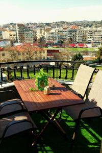 a wooden table with a plant on a balcony at Sky view suite serres in Serres