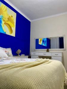 a bedroom with a blue wall and a bed at Elbasan view point in Elbasan