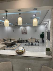 a living room with a couch and a table at Beitk Al-ula Apartments شقق بيتك العلا in AlUla +11 photos