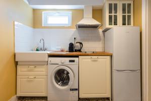 a kitchen with a refrigerator and a washing machine at Urban Senses Apt #2, a KalamataStay Property in Kalamata