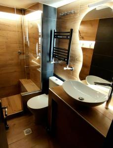 a bathroom with a sink and a toilet and a shower at Sky view suite serres in Serres