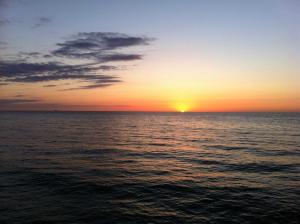 a sunset over the ocean with the sun in the sky at Fewo Möwenweg 8 - Damme GM 69180 in Graal-Müritz