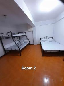 two bunk beds in a room with a wooden floor at Mountain Fog Transient House in Baguio +27 photos