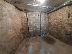 an empty room with a brick wall and a room with a brick at La Flûte 2 in Thiers