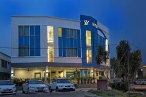 un edificio con coches estacionados frente a él en U Design Hotel Bukit Mertajam, en Bukit Mertajam
