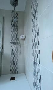 a bathroom with a shower with white tiles at Vivez le Port de plaisance - Plage in Le Havre