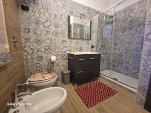a bathroom with a toilet and a sink and a shower at Casa Sabrina in San Vito lo Capo +42 photos