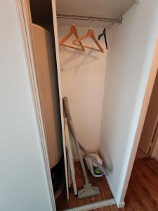 a closet being remodeled with a hanger and a broom at Studio Disneyland Paris 10min/Val d'Europe 5min/Wifi/TV in Montévrain