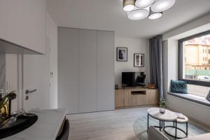 a living room with a table and a tv at Apartment EDIAS in Banská Bystrica