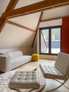 a living room with a couch and a laptop at Unique design triplex with rooftop terrace in Mechelen
