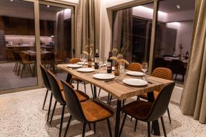 a wooden table with chairs and a dining room at City House - Hersonissos Center - Sleeps 8 in Hersonissos