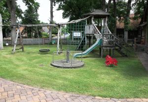a playground with a slide in a yard at Büchtmannshof in Wietze