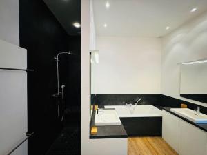 a white bathroom with two sinks and a shower at Amazing 3 bedrooms - Place Brugmann in Brussels