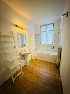 a bathroom with a sink and a toilet and a bath tub at Amazing 3 bedrooms - Place Brugmann in Brussels