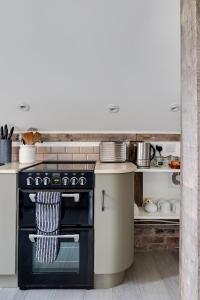 a kitchen with a black oven and a counter at Oak Tree Hideaway in Whitchurch