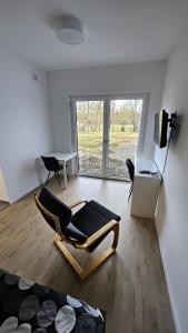 a living room with a chair and a table at Ferienwohnung Hesse Ilsede in Ilsede