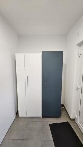 a room with white cabinets and a blue door at Ferienwohnung Hesse Ilsede in Ilsede