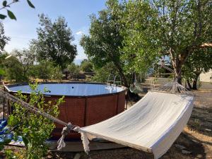a hammock in front of a swimming pool at Cabañas Manquel in Antuco