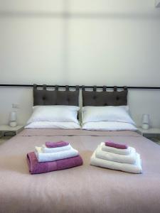 two towels on a bed with two pillows on it at Puzzle Rooms in Campobasso