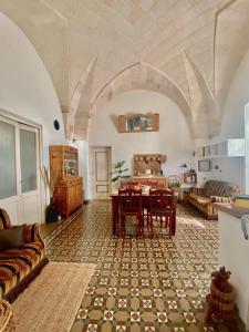 a living room with a table and a couch at Casa Marugii in Maruggio