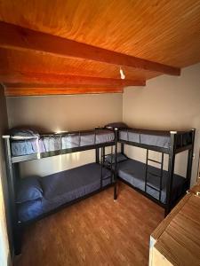 two bunk beds in a room with a ceiling at Xperience Hostel in San Pedro de Atacama
