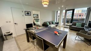 a living room with a ping pong table in it at Lux Livin' Apartments - Luxury 2 Bed Apartment with Sky Garden in Manchester