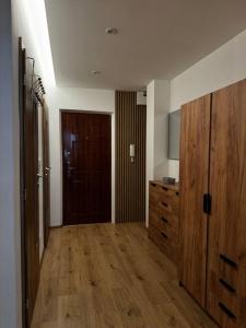 a room with a wooden door and a wooden floor at Apartman Amur in Košice