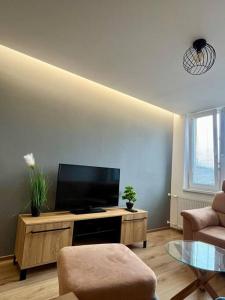 a living room with a flat screen tv on a table at Apartman Amur in Košice
