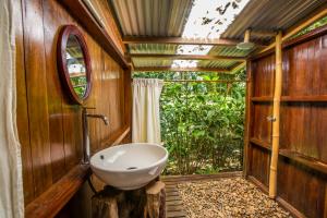 a bathroom with a toilet and a sink in it at Hacienda Herrera Tambopata in Puerto Maldonado