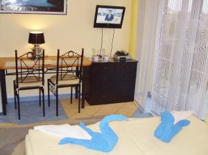 a bedroom with a table and a bed with two blue towels at Cyklada, śniadania, jezioro,przystań,tawerna-200m, centrum-900m, park linowy-400m,aquapark-900m in Mikołajki
