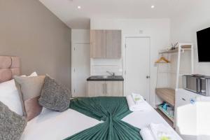 Zimmer mit einem Bett und einer Küche in der Unterkunft The Best City Studio Near Public Transport in Ealing