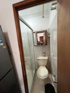 a bathroom with a toilet and a glass shower at aparta estudio en envigado in Envigado