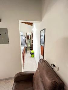 a living room with a couch and a mirror at aparta estudio en envigado in Envigado