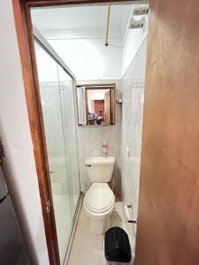 a small bathroom with a toilet and a shower at aparta estudio en envigado in Envigado
