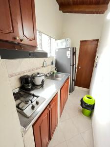 a kitchen with a stove and a refrigerator at aparta estudio en envigado in Envigado