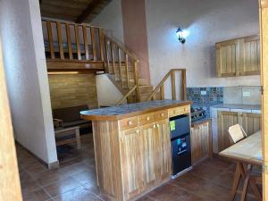 a kitchen with a counter and a staircase in a room at CasaDolomiti Coban Guest House in Cobán