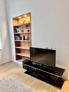 a flat screen tv sitting in a living room at Vieil Antibes Apartment with AC 320m from Beach in Antibes