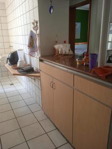 a kitchen with a sink and a counter top at Apart Quartier Latin in Vitória