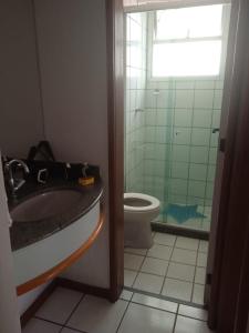 a bathroom with a sink and a toilet at Apart Quartier Latin in Vitória +2 photos