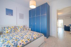 a bedroom with a blue cabinet and a bed at 1-bedroom 500m away from the beach in Kallithea Halkidikis